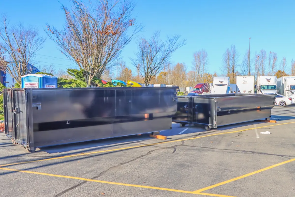 Professional dumpster rental service with roll-off container on residential driveway in Sebastian